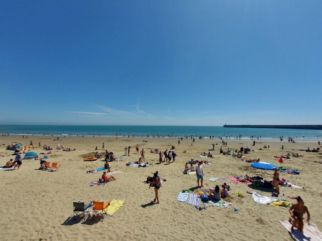 People enjoy sun bathing at Sunny Sands, lovely sunny sky