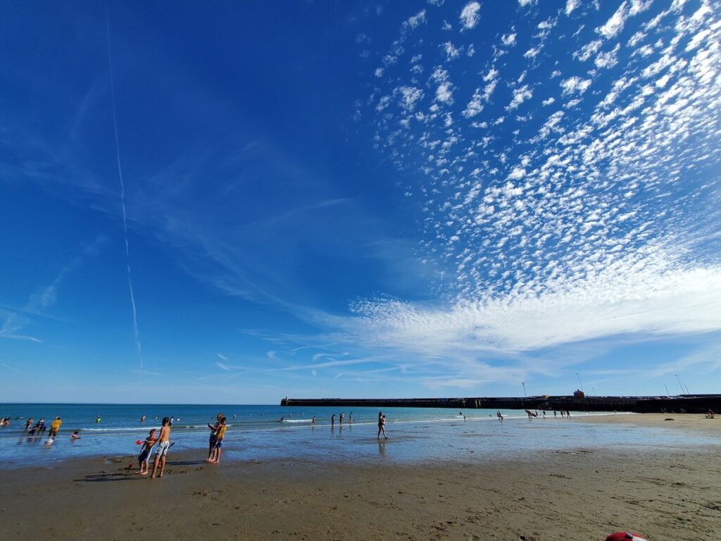 People enjoying the beach and playing with sands at Sunny Sands Beach